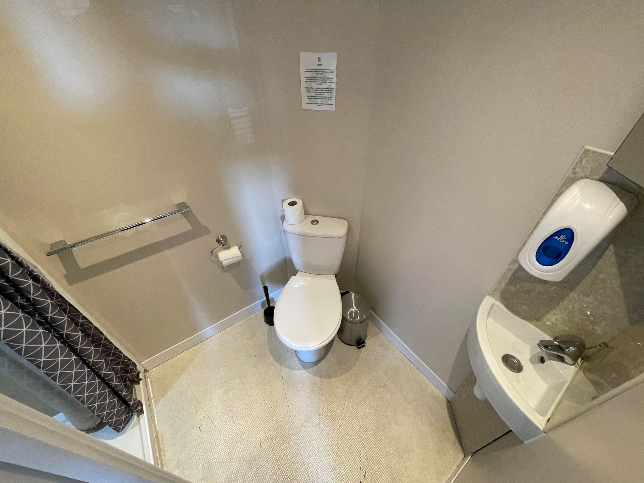 A bathroom with a toilet, bidet, and sink.