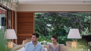 A couple seated at a table with a view of lush greenery outside. - The Atta Terrace Club Towers (Onna)