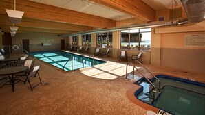 A pool area with a hot tub, lounge chairs, and a sign indicating no lifeguard on duty. - Hampton Inn Marquette/Waterfront (Marquette)