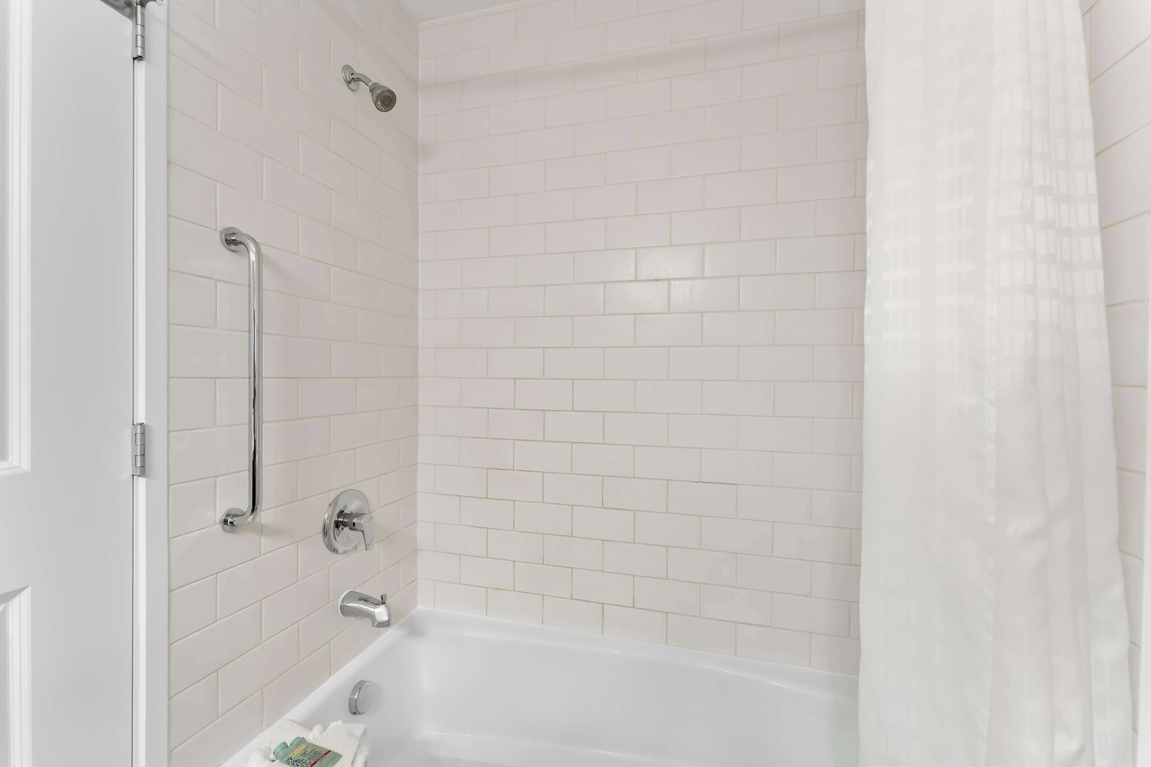 standard room, 2 queen beds, non smoking, refrigerator & microwave | bathroom | combined shower/bathtub, free toiletries, hair dryer, towels