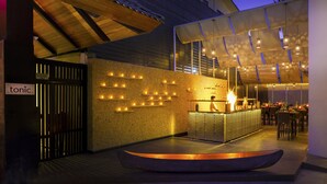 A modern bar area with a counter, seating, and ambient lighting. - Hard Rock Hotel Goa Calangute (Calangute)