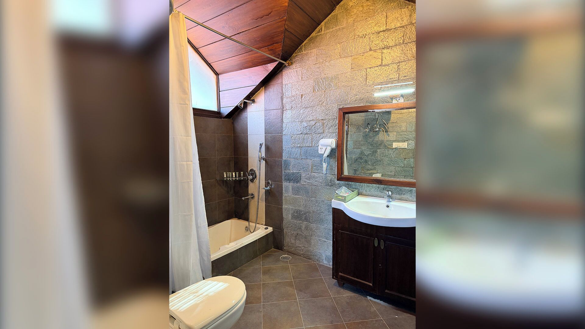 A bathroom with a shower, toilet, and sink.
