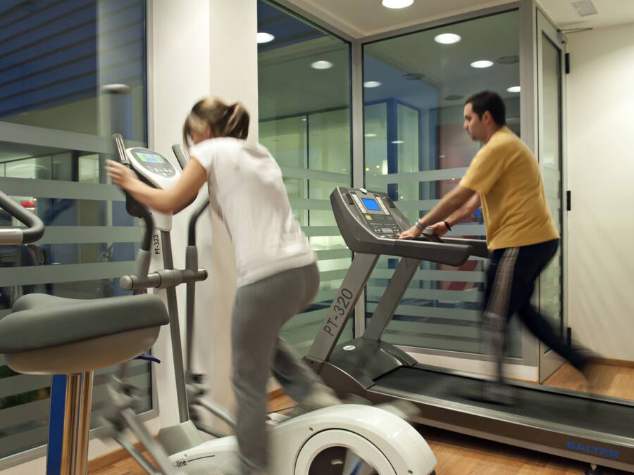 A gym with treadmills and exercise equipment.