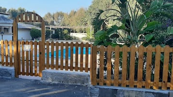 Outdoor pool, open 10 AM to 7 PM, pool umbrellas, pool loungers