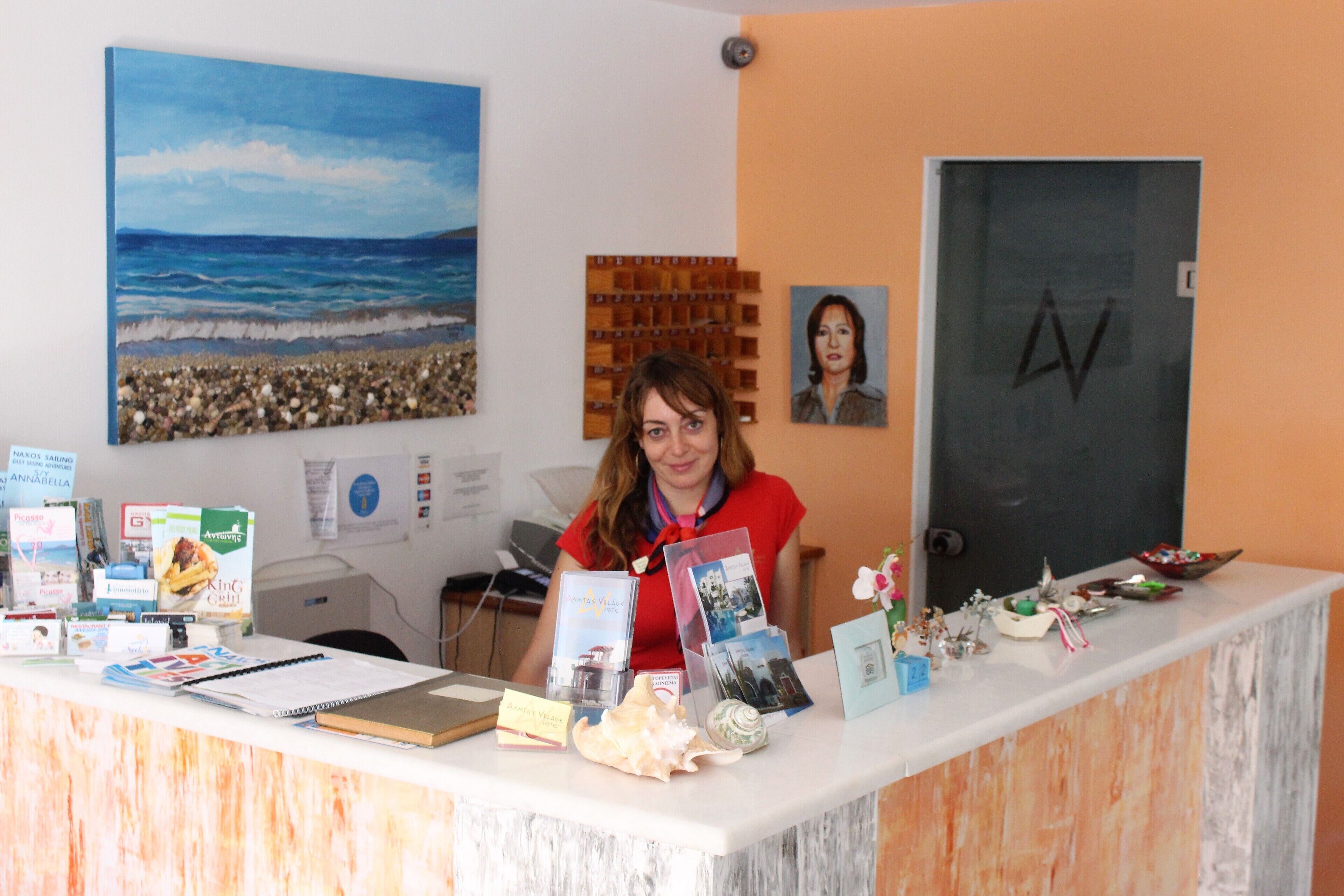 A reception desk with various items including books, a notebook, and a decorative shell.