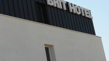 Um edifício com uma placa na fachada que diz "BRIT HOTEL".