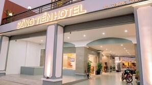 The exterior of Song Tien Hotel with a modern facade, large columns, and a visible entrance. - Song Tien Hotel (My Tho)