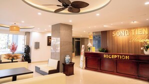 A hotel reception area with a reception desk labeled "RECEPTION," a ceiling fan, and a sign that reads "SONG TIEN Hotel." - Song Tien Hotel (My Tho)