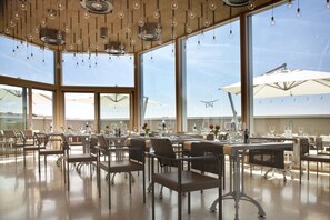 Enjoy a bright and airy dining experience with large windows and elegant lighting.