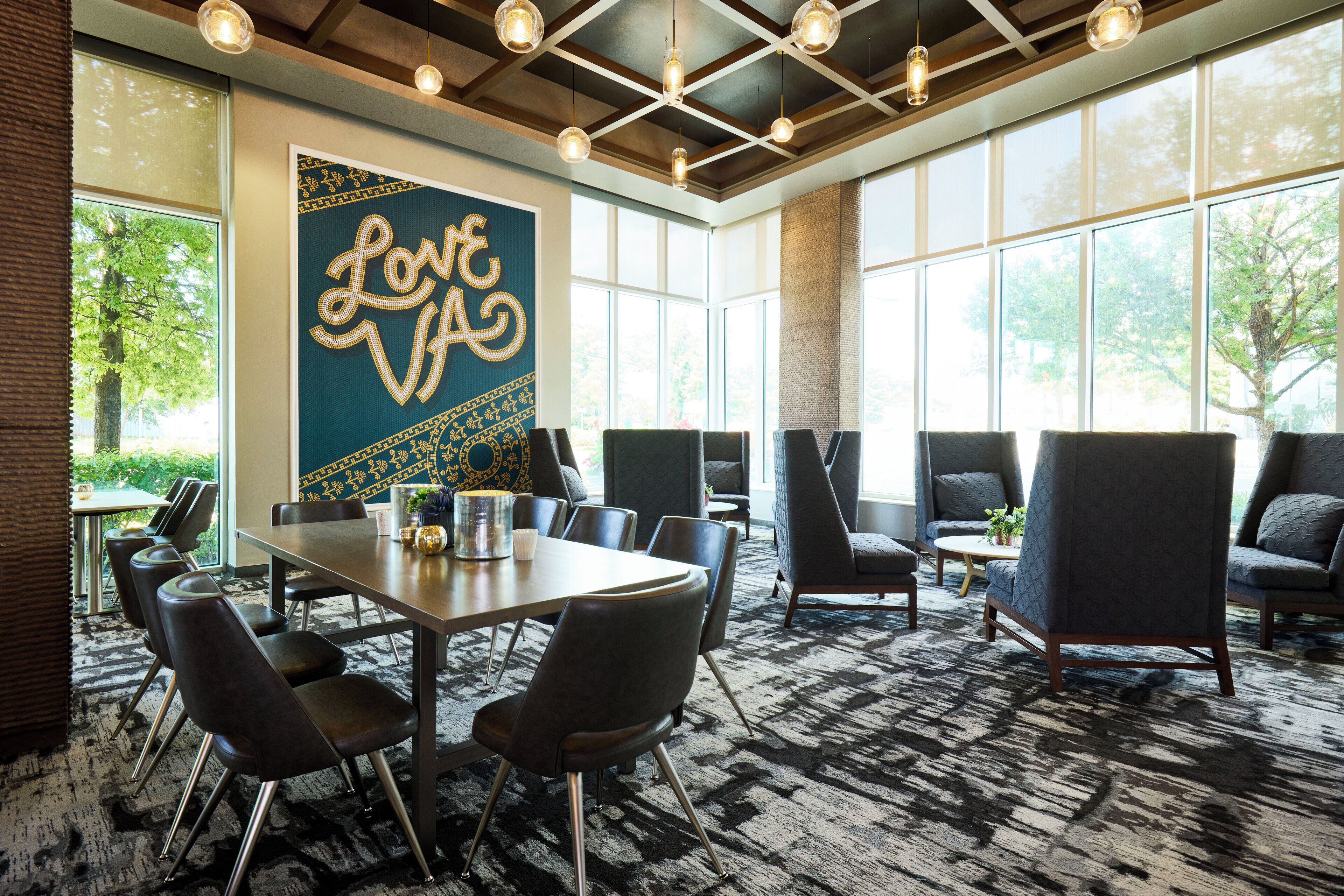 A conference room with a large table, several chairs, and a 'Love VA' sign on the wall.