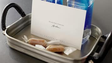 A tray with a card, two bottles, and two wrapped items.