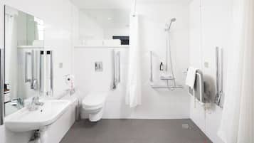 A modern bathroom with a sink, toilet, and shower.
