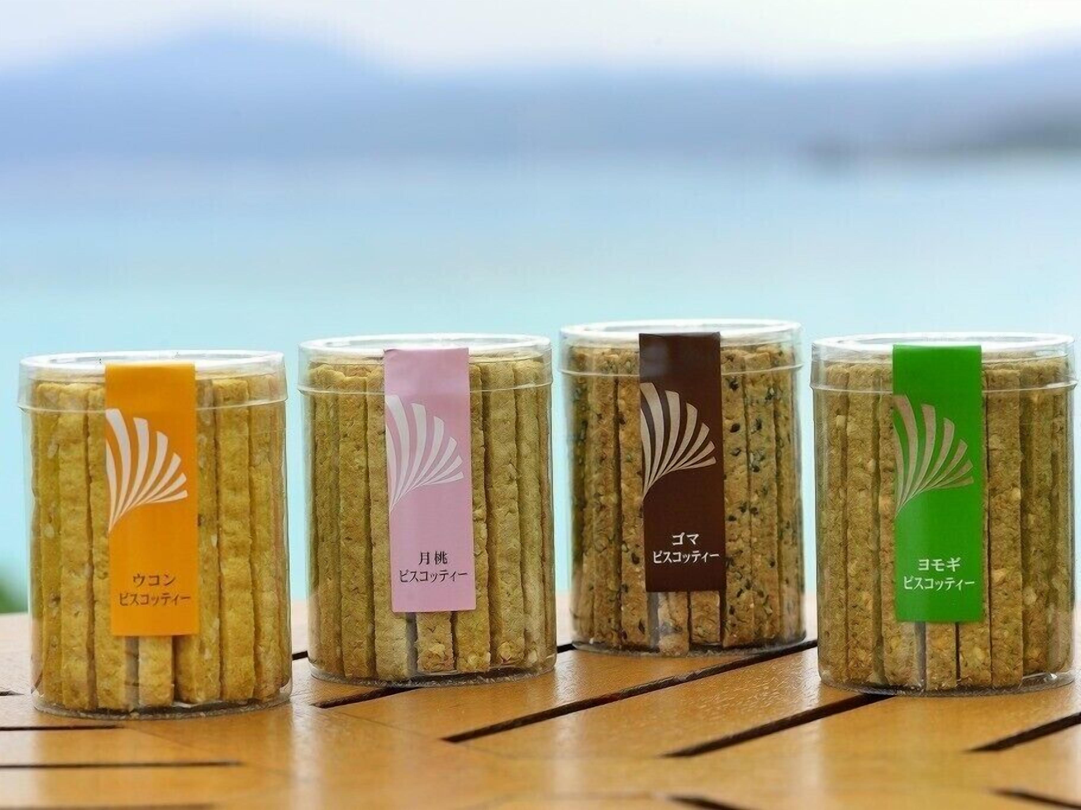 Four jars of pickled vegetables with labels in different colors.