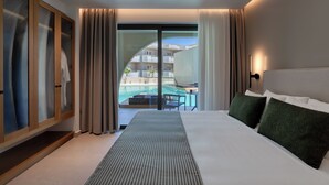 A hotel room with a bed, a view of a pool, and a sliding glass door. - Dore Hotel (Chania)