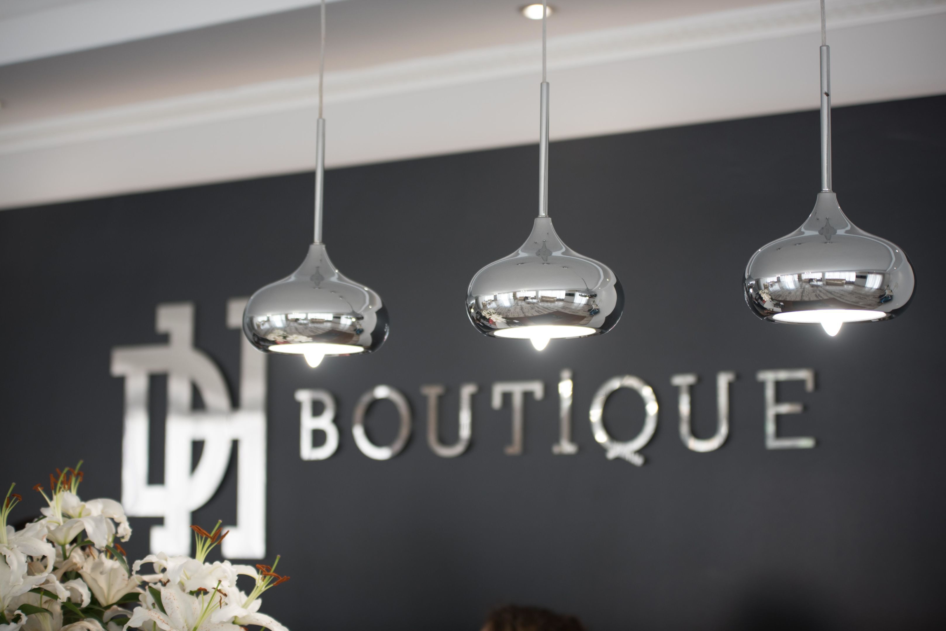 A boutique with pendant lighting and a floral arrangement.