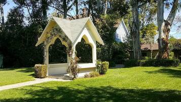 Situated amidst mature trees, this gazebo offers a serene retreat.