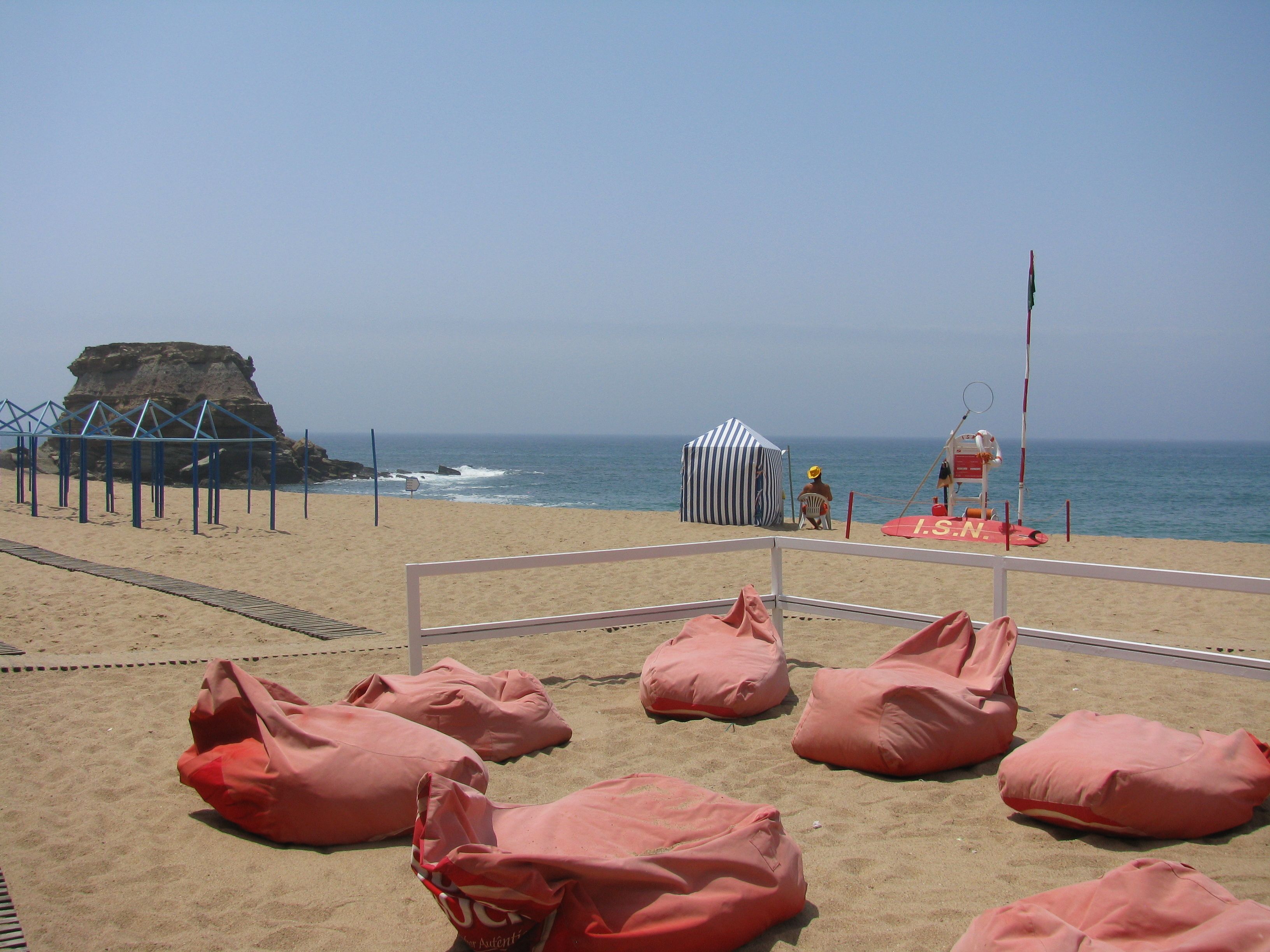 on the beach, white sand, beach cabanas, sun-loungers