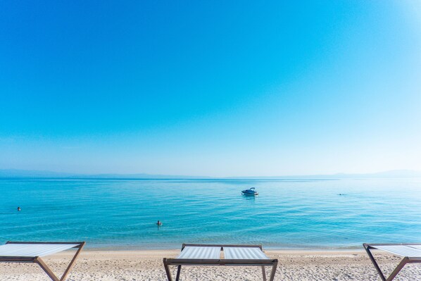 Plage privée, cabines (en supplément), chaises longues, parasols