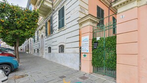 A street view with a building labeled 'LUNAMAR' and a reception sign. - Affittacamere Lunamar (La Spezia)