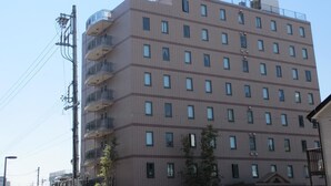 A multi-story hotel with a flat facade, balconies on the upper floors, and a sign indicating it is a hotel. - Ace Inn Kariya (Kariya)