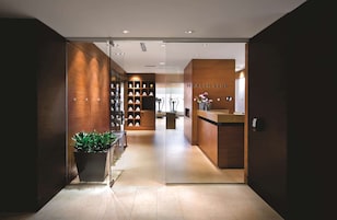 A modern health club interior with a reception desk, exercise equipment, and a well-organized reception area.