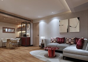 A modern living room with a sofa, coffee table, and a dining area with chairs and a table. - The Aarlis Hotel Panchkula, Vignette Collection by IHG (Panchkula)