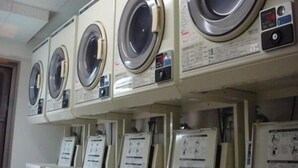 A row of stacked washing machines in a utility room. - Kuretake Inn Iwata (Iwata)