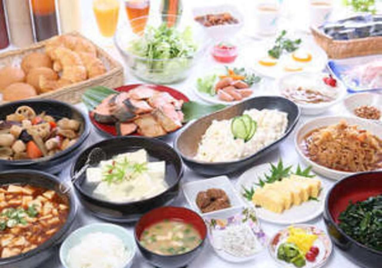 A table with various dishes, including seafood, rice, and vegetables.