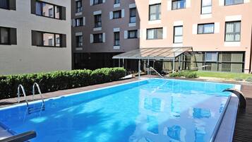 Seasonal outdoor pool, open 7:00 AM to 10:00 PM, sun loungers