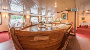 A wooden bar area with a sign reading "MS Florentina" on a cruise ship.