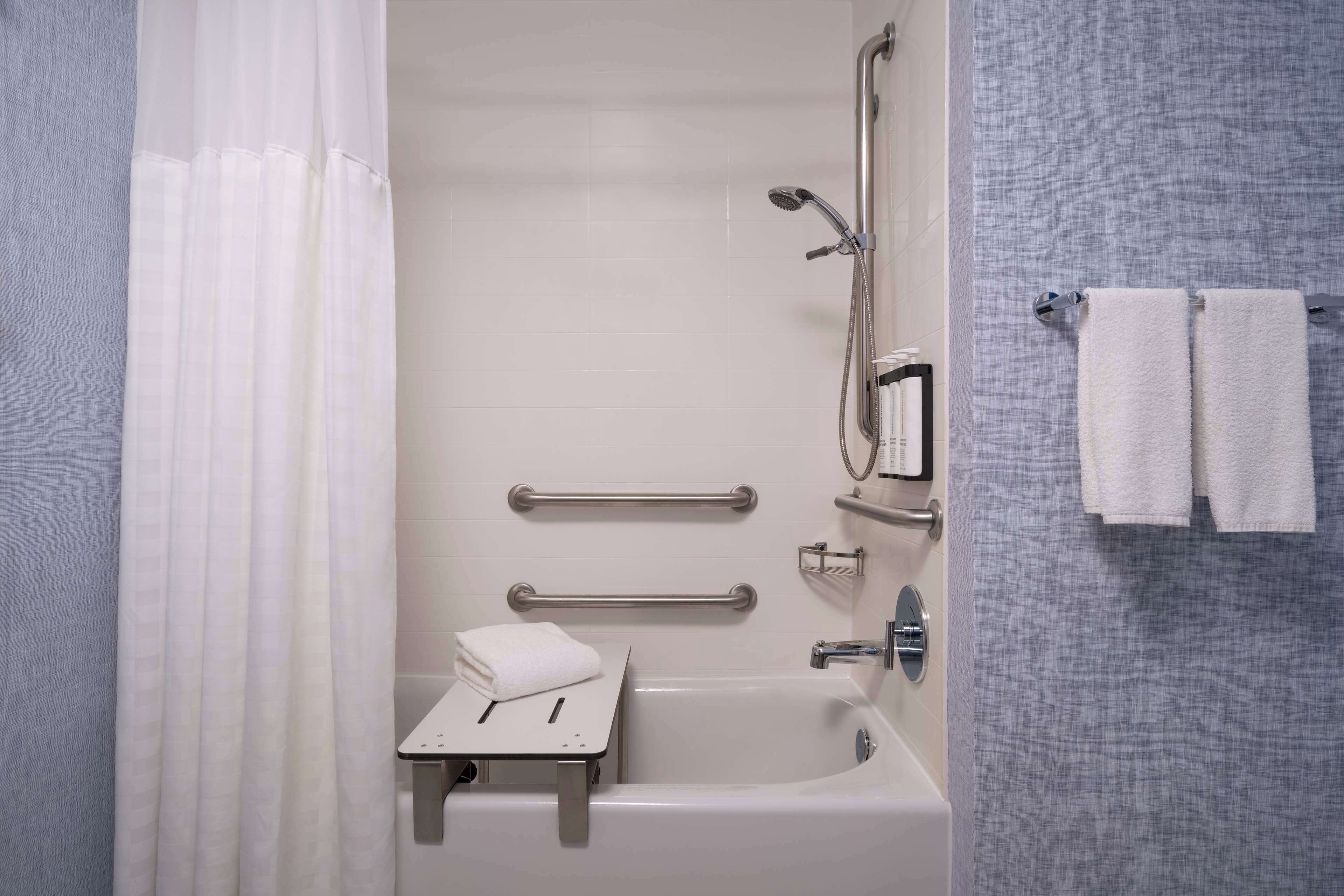 designer toiletries, hair dryer, towels