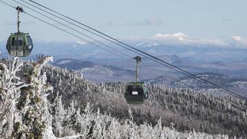 A cable car system in a snowy mountainous area.