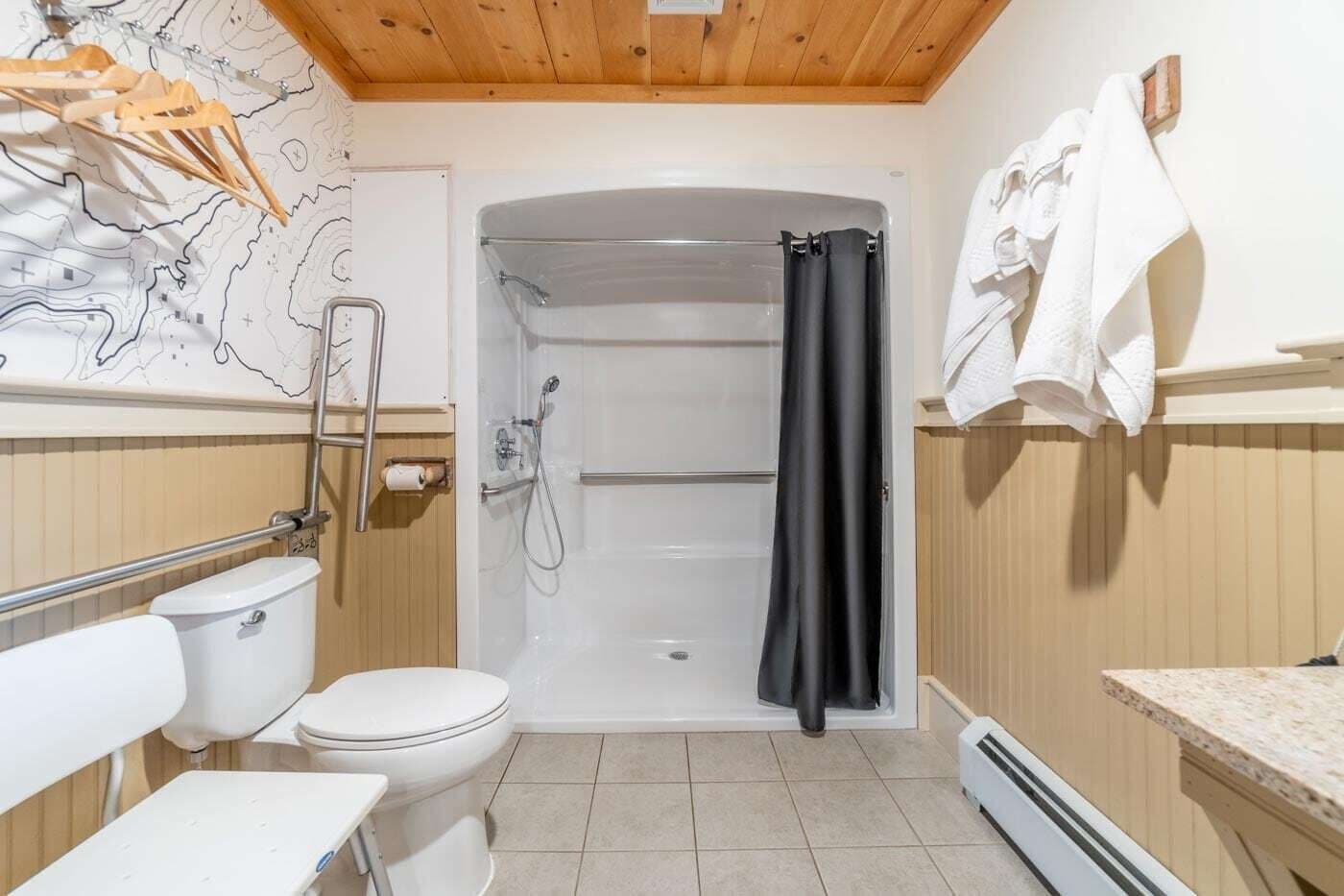 A bathroom with a shower, toilet, and sink.