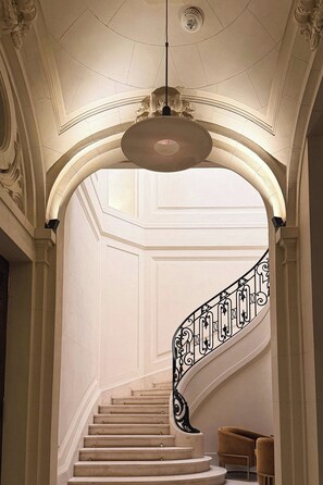 A grand staircase with ornate railings and a ceiling light fixture. - Recoleta Grand, a Tribute Portfolio Hotel (Buenos Aires)