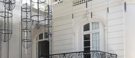 A checkered floor, a bar area, and a balcony with ornate railings.
