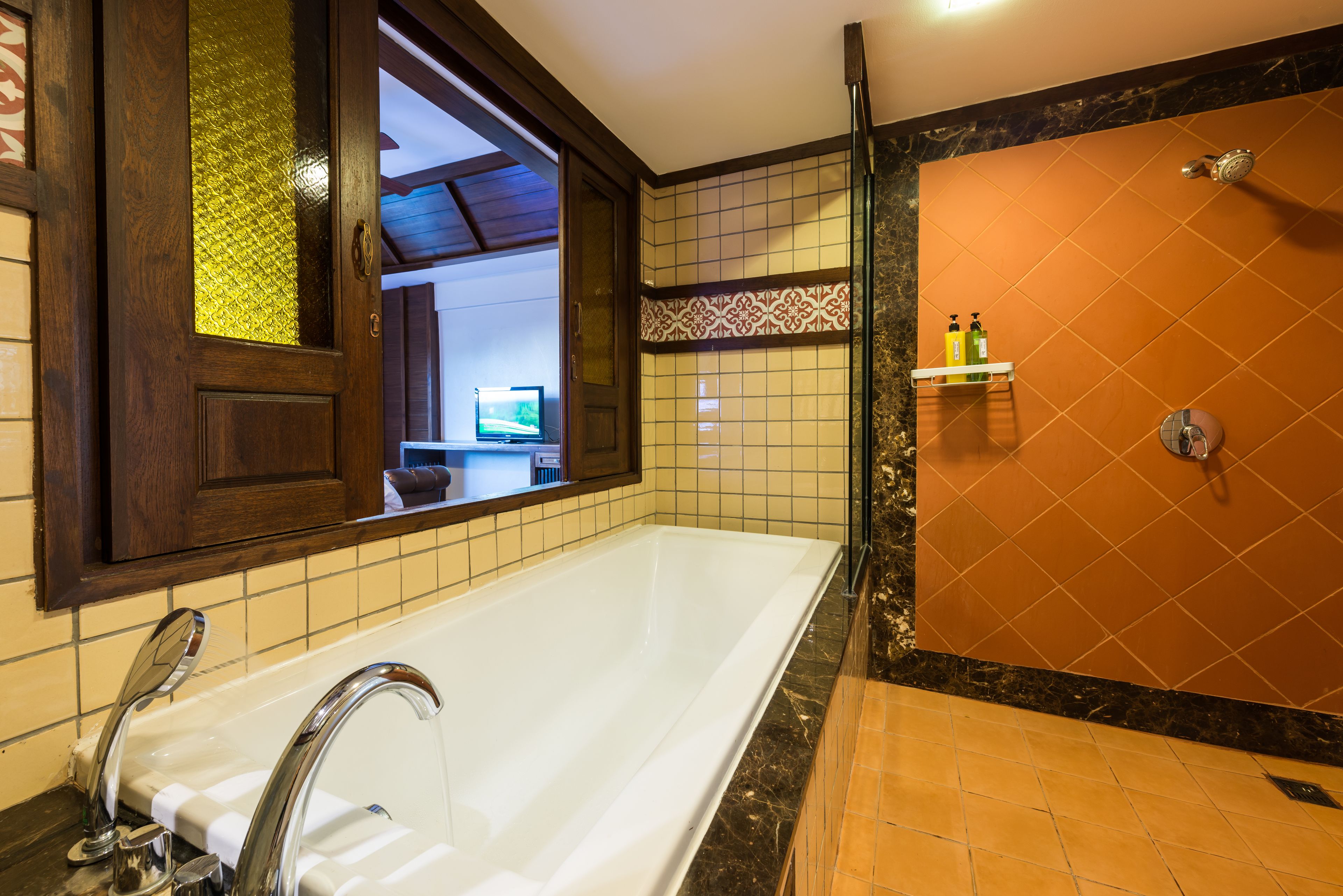 A bathroom with a bathtub, a shower, and a sink.