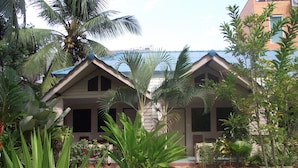 A row of two-story buildings with a stone pathway leading to the entrance. - The Krabi Forest Homestay (Krabi)