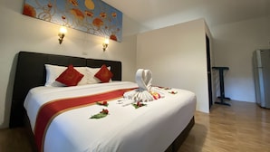 A hotel room with a large bed, a headboard, a wall painting, and a ceiling light. - The Krabi Forest Homestay (Krabi)