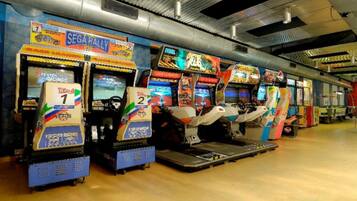 Experience the thrill of classic arcade games in our retro gaming area, featuring SEGA Rally and 2 Player Racing.