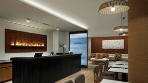 A modern hotel lobby with a reception desk, seating area, and a large window. - The Fern Residency Mumbai, The Acres Chembur, Series by Marriott (Mumbai)