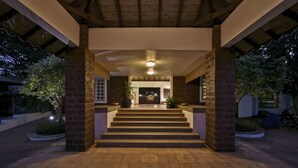 A covered outdoor staircase leading to a building entrance, surrounded by brick pillars and potted plants. - The Fern Samali Resort Dapoli, Series by Marriott (Dapoli)
