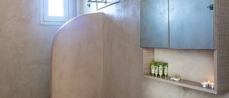 A modern bathroom with a shower, toilet, and sink.