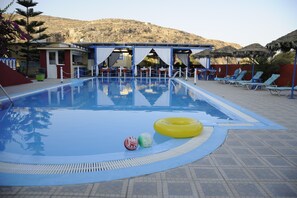 Seasonal outdoor pool, open 8:00 AM to 9:00 PM, pool umbrellas