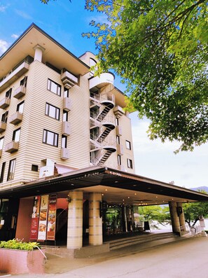 A multi-story hotel with a distinctive spiral staircase, a covered entrance, and a tiled facade. - Fuji Lake Hotel (Fujikawaguchiko)