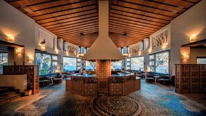 A spacious lobby with a high ceiling, large windows, and a central bar area. - Fuji Lake Hotel (Fujikawaguchiko)