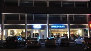 A multi-story building with illuminated signage for 'Mia' and 'Buzzgear'. - Maya Hotel (Chandigarh)