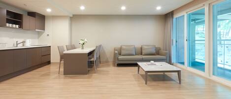 A modern living room with a dining area, a sofa, and a coffee table.