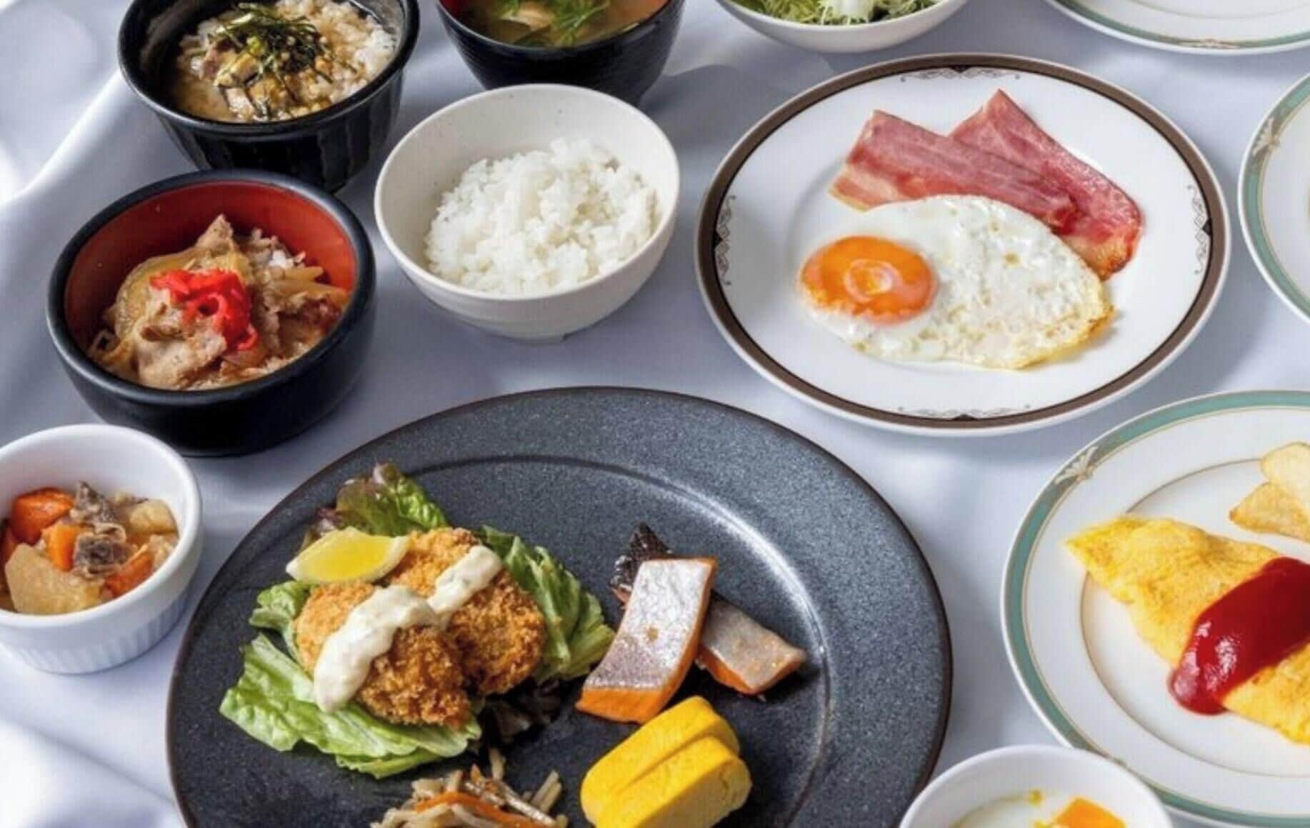A variety of dishes including rice, fried egg, and meat, suggesting a meal setting.
