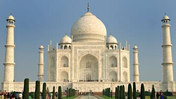 The Taj Mahal with four minarets, a large central dome, and a symmetrical facade.