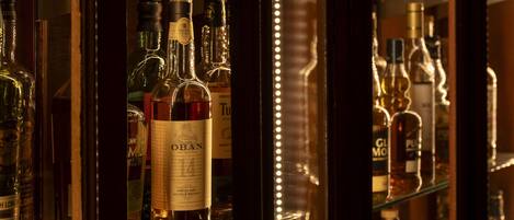 A bar with shelves of various liquor bottles.